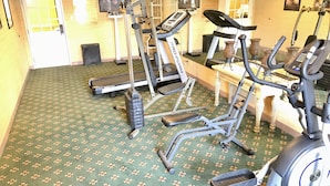 A fitness room with treadmills, elliptical machines, and stationary bikes. - Super 8 by Wyndham Temple I-35 (Temple)