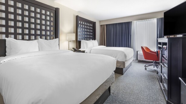 A hotel room with two beds, a TV, a desk, and a chair. - Comfort Inn Plano-Dallas (Plano)