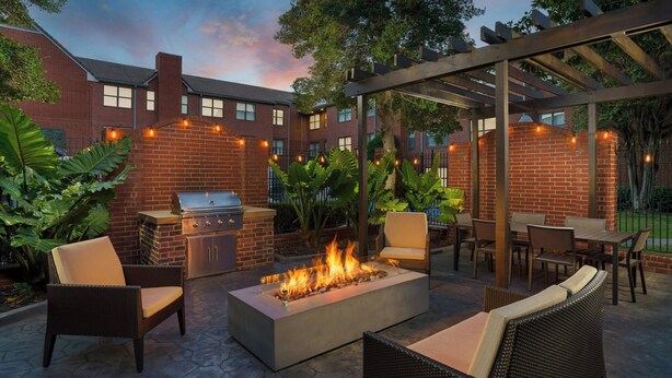 An outdoor patio with a fire pit, seating, and a grill area. - Residence Inn by Marriott Dallas Addison/Quorum Drive (Dallas)