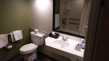 A bathroom with a toilet, sink, and shower.