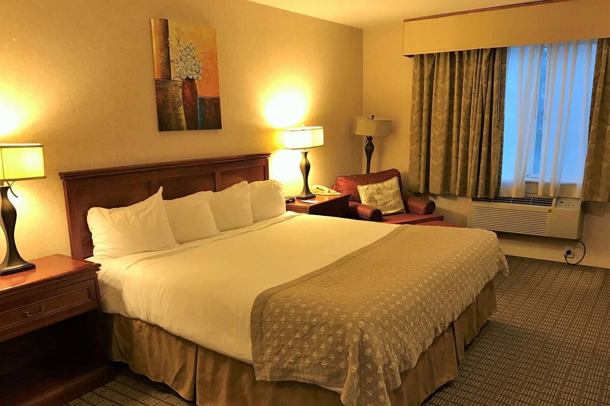 Desk, laptop workspace, blackout drapes, iron/ironing board