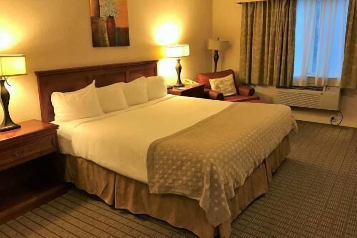 Desk, laptop workspace, blackout drapes, iron/ironing board