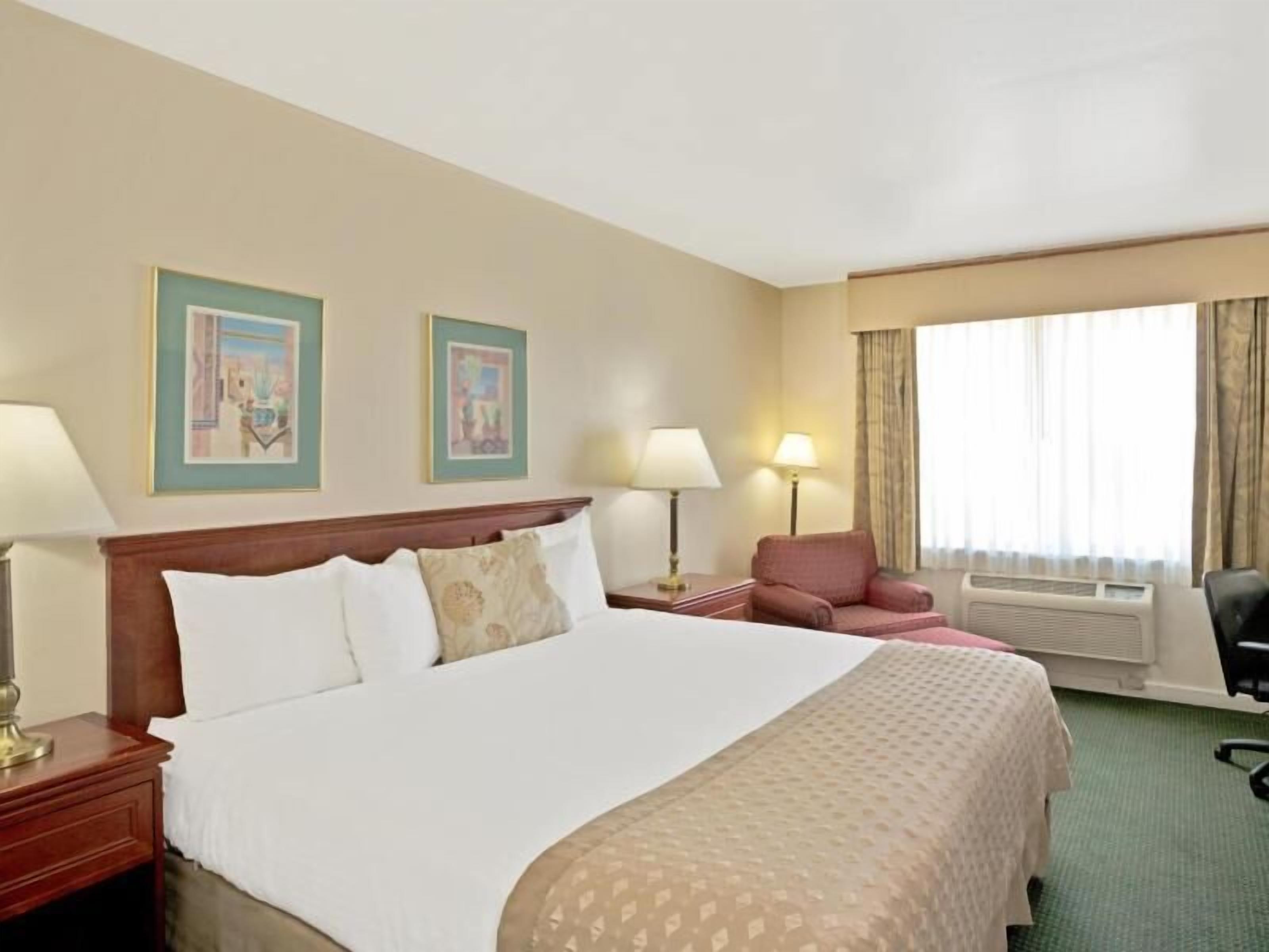 Desk, laptop workspace, blackout drapes, iron/ironing board