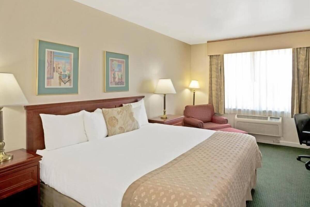 Desk, laptop workspace, blackout drapes, iron/ironing board