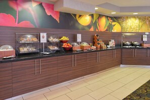 A buffet area with various food stations, including a fruit bowl and a beverage dispenser. - Fairfield Inn by Marriott Salt Lake City Layton (Layton)