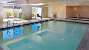An indoor swimming pool with clear water, a diving board, and several lounge chairs. - Fairfield Inn by Marriott Salt Lake City Layton (Layton)