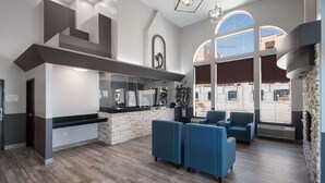 A modern interior with a bar area, seating, and large windows. - Quality Inn Midvale - Salt Lake City South (Midvale)