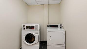 A laundry room with a front-loading washing machine and a top-loading dryer.