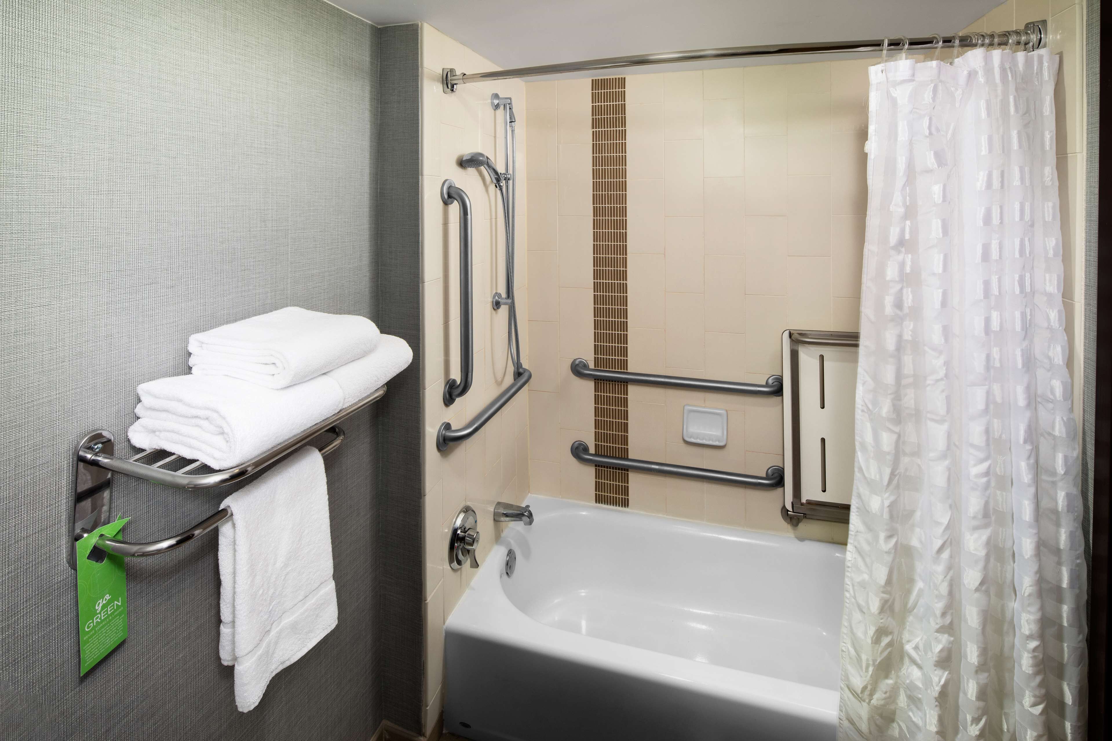 combined shower/bathtub, designer toiletries, hair dryer, towels