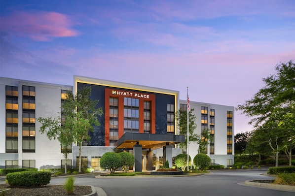 A modern hotel with a prominent sign reading "HYATT PLACE".