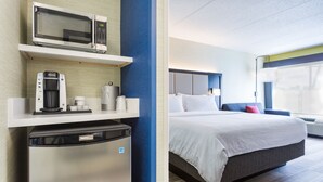 A hotel room with a bed, a microwave, a coffee maker, and a mini-fridge. - Holiday Inn Express Lorton by IHG (Lorton)