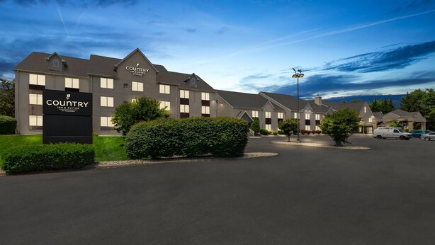 A Country Inn & Suites hotel with a modern design, featuring a large signboard, well-maintained landscaping, and a parking area. - Country Inn & Suites by Radisson, Roanoke, VA (Roanoke)