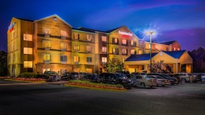 A multi-story Fairfield Inn Marriott hotel with a parking lot in front.