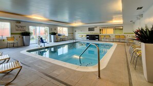 An indoor swimming pool with a no diving sign, surrounded by chairs and potted plants. - Fairfield Inn By Marriott Potomac Mills (Woodbridge)