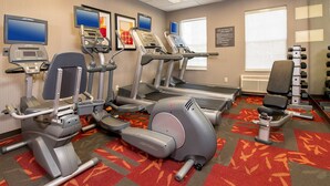 A fitness center with treadmills, elliptical machines, and weight machines.