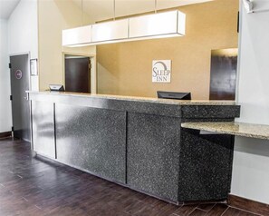 A reception desk with a sign reading "Sleep Inn" and a Dell computer. - Sleep Inn Richmond South (Richmond)