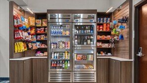 A self-service beverage station with multiple refrigerators stocked with various drinks and snacks. - Holiday Inn Express Wenatchee by IHG (Wenatchee)
