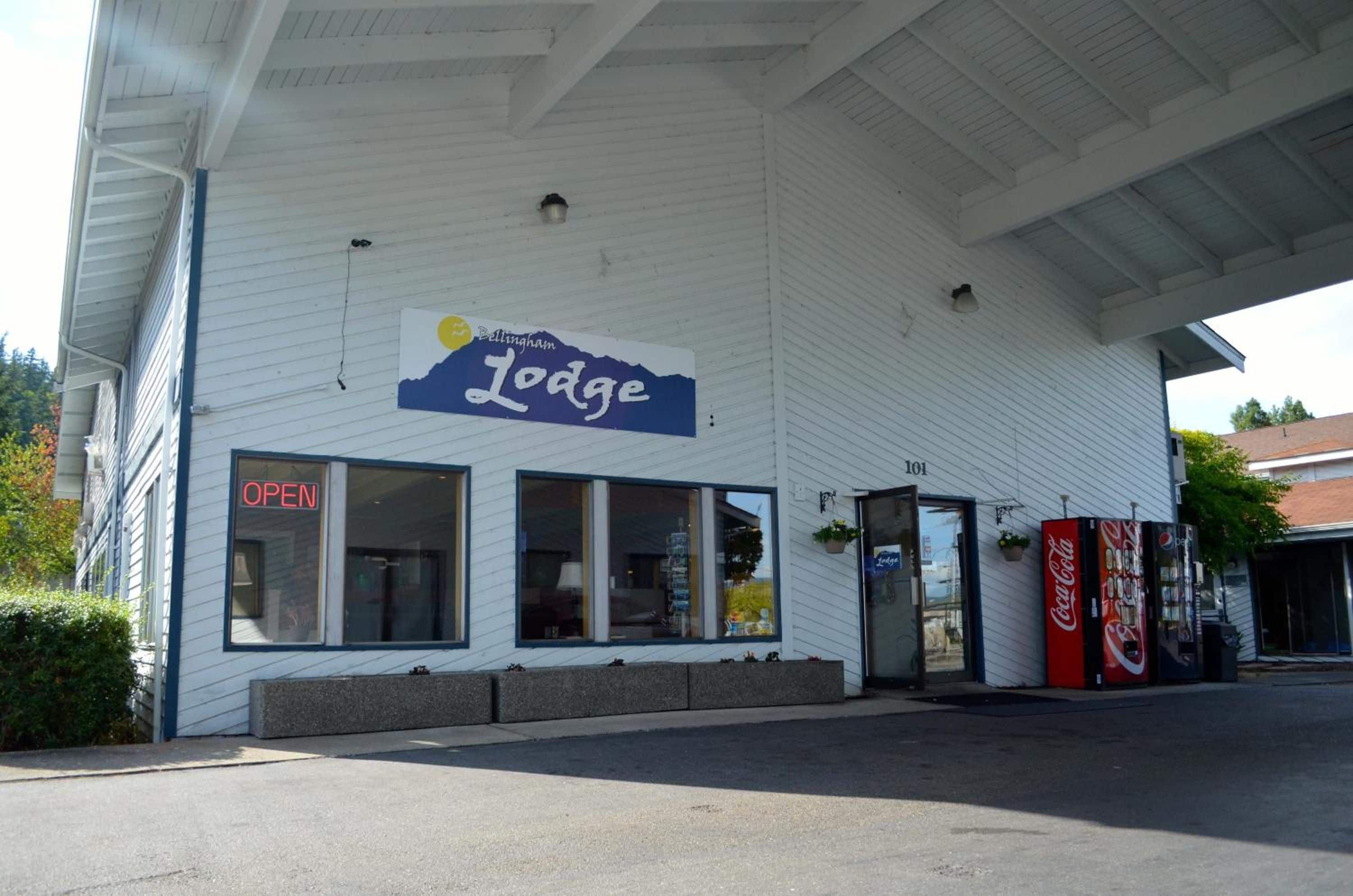 A building with a sign reading 'Bellingham Lodge' and a Coca-Cola vending machine outside.