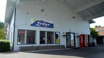 A building with a sign reading 'Bellingham Lodge' and a Coca-Cola vending machine outside.