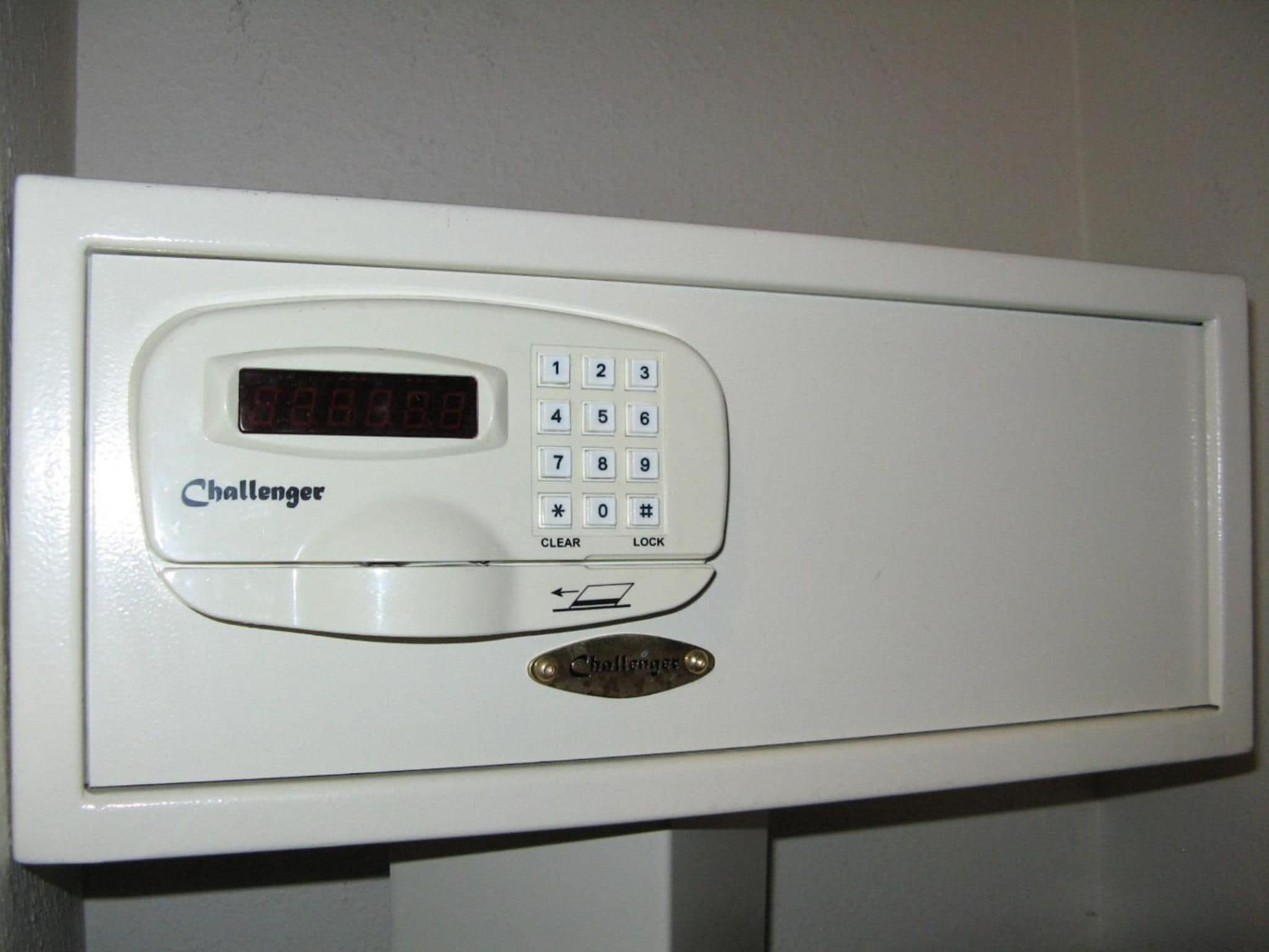 A white electronic device with a keypad and a digital display, labeled 'Challenger.'