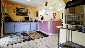 A kitchen with a central island, a refrigerator, and a ceiling fan.