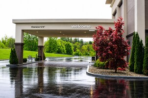 A covered entrance with a 'welcome' sign and a 'Clearance 12'6' height' sign.