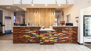 A reception desk with a wooden panel design and a colorful mosaic pattern. - Best Western Watertown (Watertown)