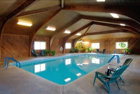 Indoor pool, open 7:00 AM to 10:00 PM, pool umbrellas, pool loungers. Covered Wagon Motel