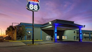 A motel with a neon sign reading "HOTEL BLUE 66" at dusk. - Hotel Blue 66, BW Signature Collection (Santa Rosa)