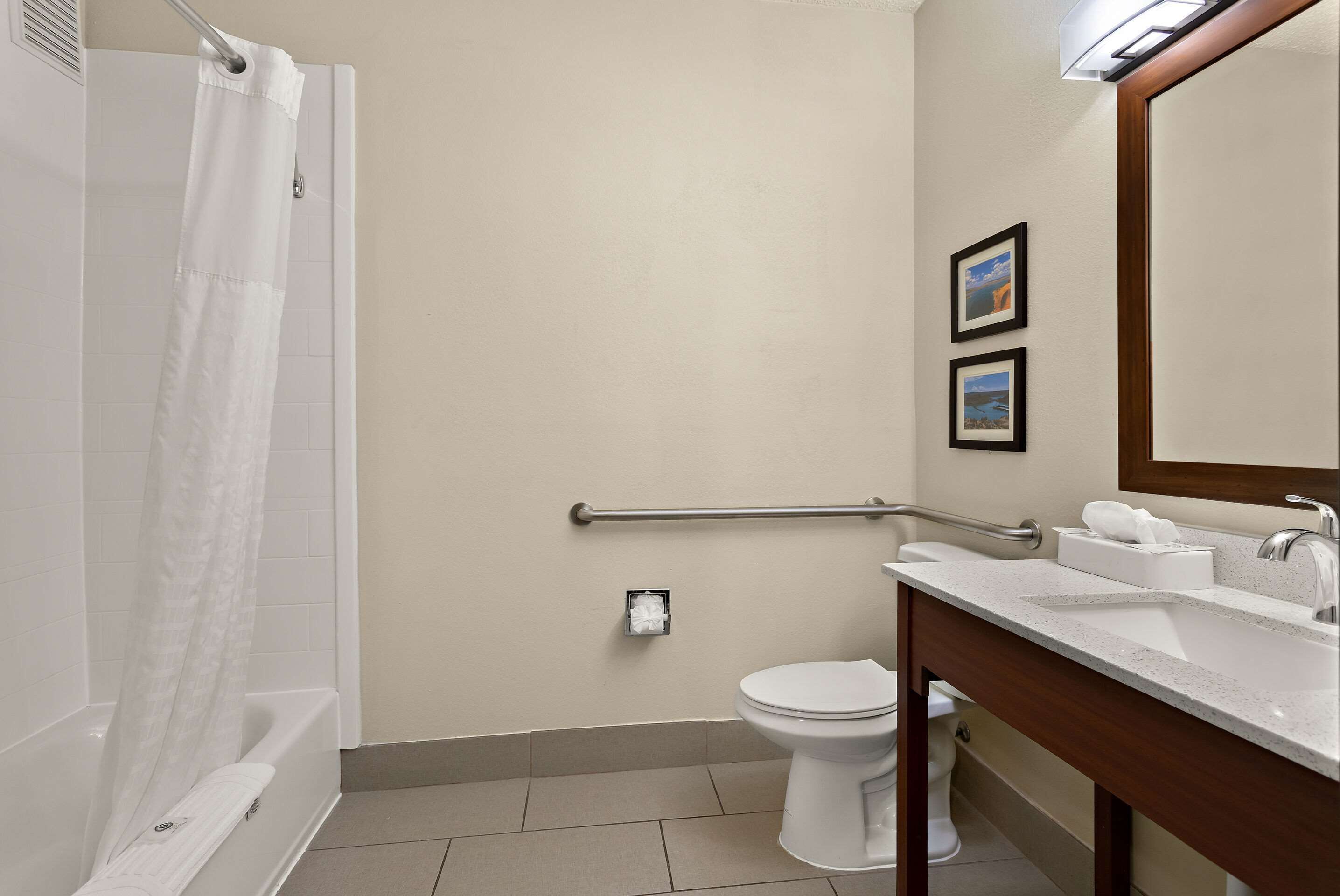 A bathroom with a shower, toilet, and sink.