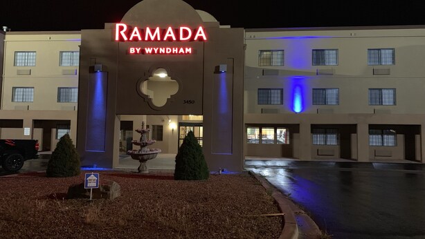 A hotel entrance with a neon sign reading "RAMADA BY WYNDHAM" and the number "3450". - Ramada by Wyndham Santa Fe (Santa Fe)