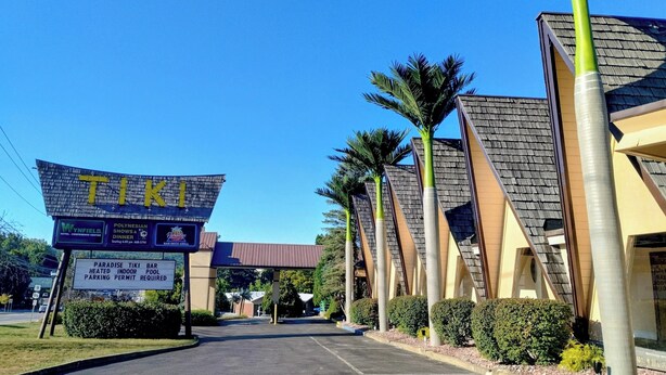 A TIKI bar with a sign indicating heated indoor pool and parking permit required.