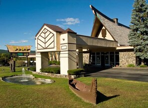A building with a distinctive architectural design, including a large entrance and a stone facade.