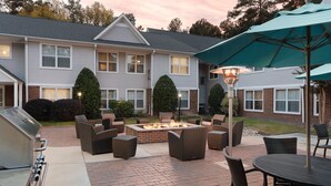 A patio area with a fire pit, outdoor furniture, and a grill. - Residence Inn by Marriott Southern Pines/Pinehurst NC (Southern Pines)