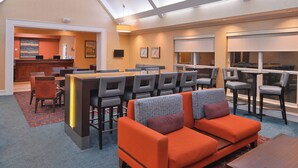 A hotel lobby with a reception desk, seating area, and large windows. - Residence Inn by Marriott Southern Pines/Pinehurst NC (Southern Pines)