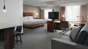 A hotel room with a bed, desk, TV, and seating area. - Residence Inn by Marriott Southern Pines/Pinehurst NC (Southern Pines)