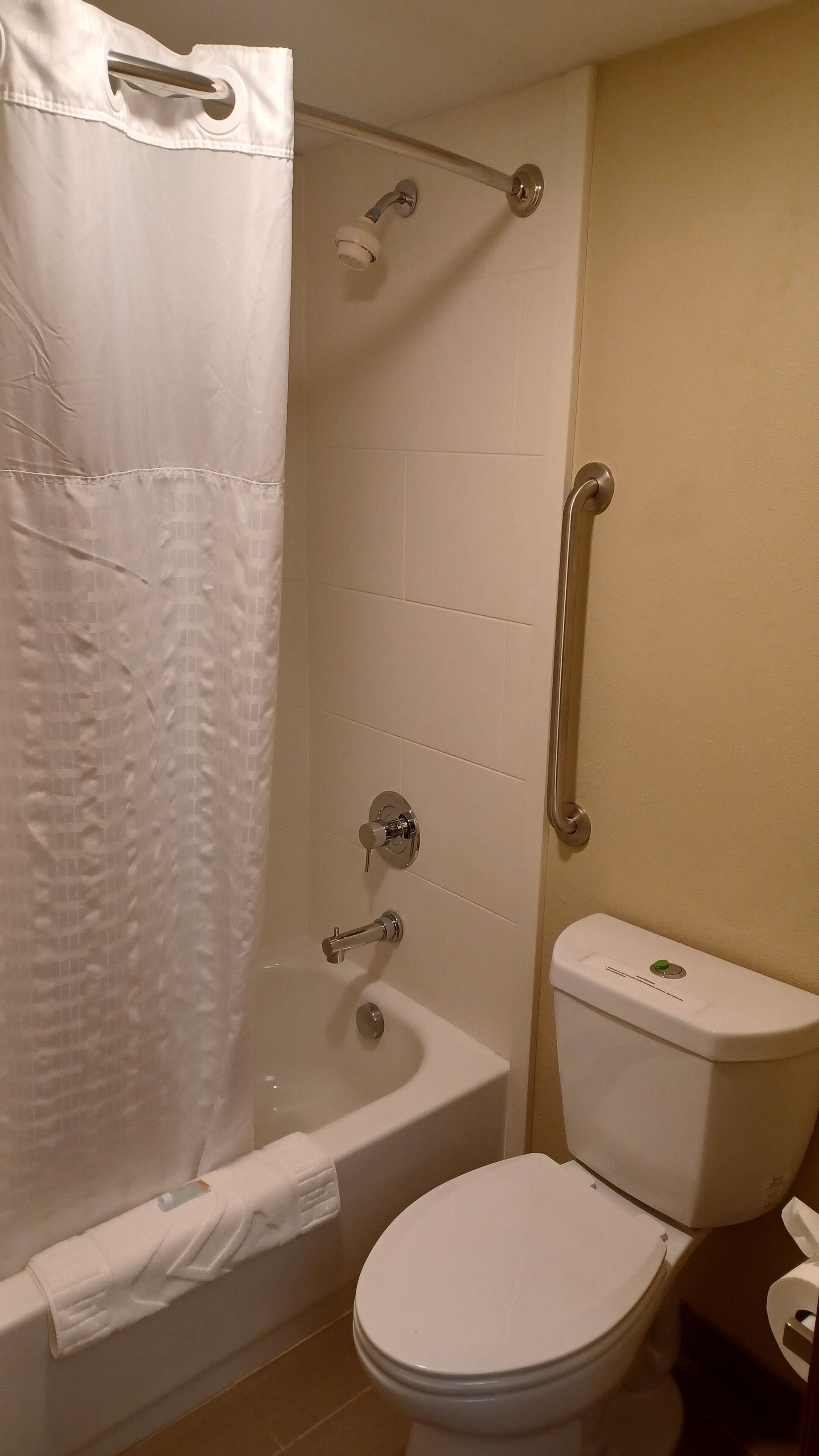 A bathroom with a bathtub, toilet, and shower.