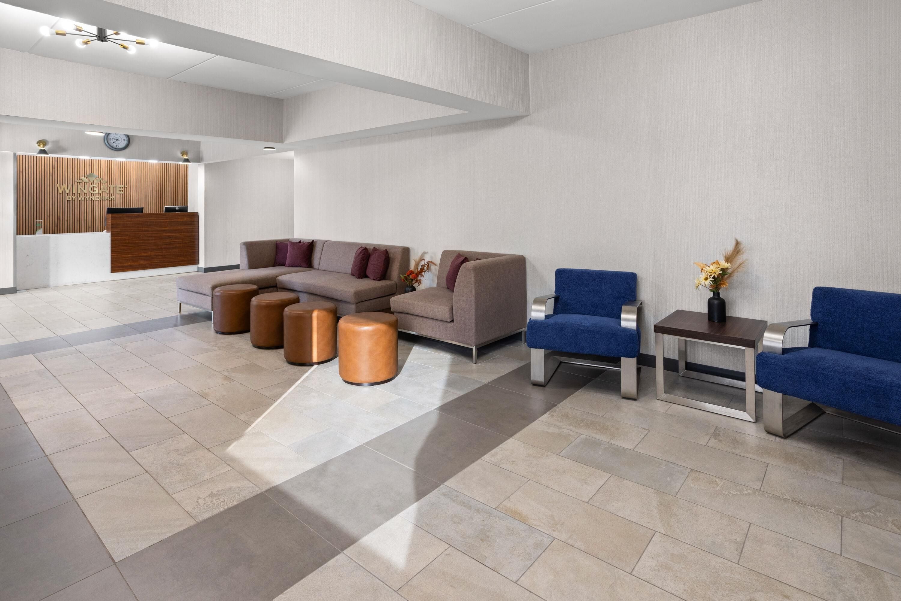 A modern reception area with a reception desk, seating arrangements, and a clock on the wall.