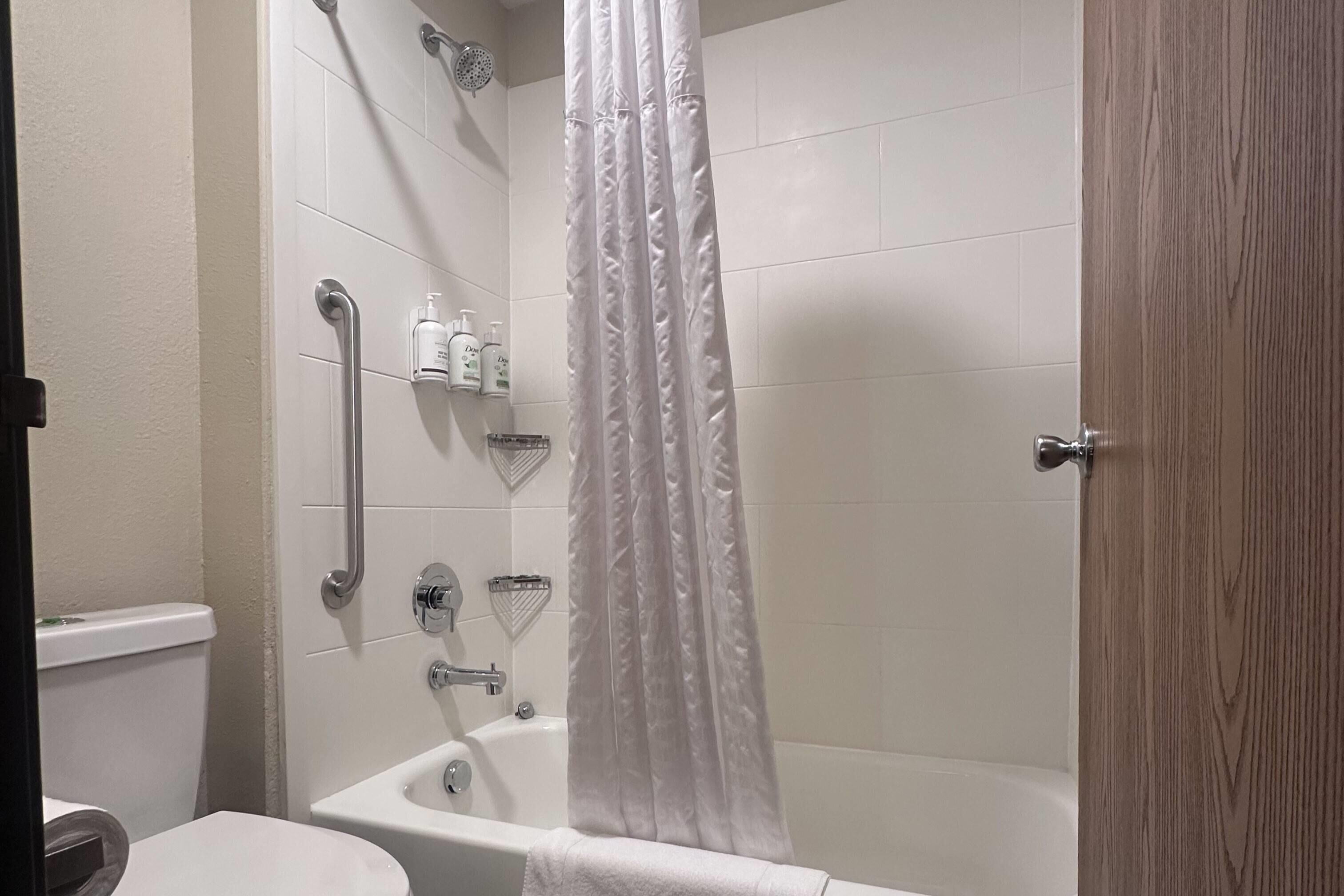 A bathroom with a bathtub, a shower, and a toilet.