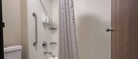 A bathroom with a bathtub, a shower, and a toilet.