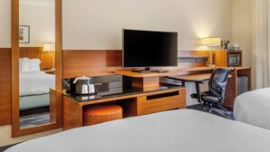 A hotel room with a bed, a desk with a flat-screen TV, a chair, a microwave, and a small refrigerator. - Fairfield Inn by Marriott Myrtle Beach North (Myrtle Beach)