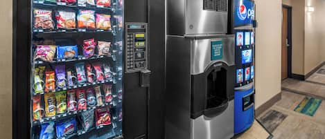 A vending machine with snacks and a water dispenser.