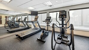 A gym with treadmills, an elliptical, and a stair climber.