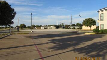 A parking lot with a building in the background.