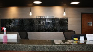 A reception desk with a sign reading "EXECUTIVE INN & SUITES." - Executive Inn and Suites Wichita Falls (Wichita Falls)