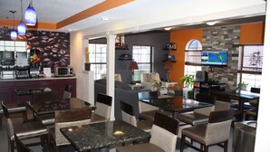 A restaurant with multiple dining areas, including a bar and a seating area with tables and chairs. - Executive Inn and Suites Wichita Falls (Wichita Falls)