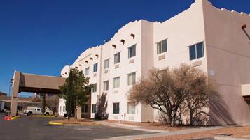 Hotel building with a flat facade and overhang above the entrance.