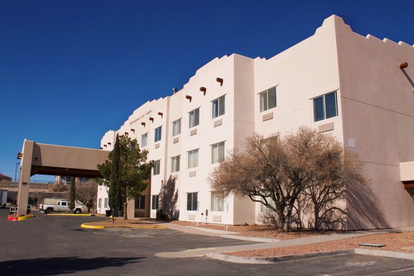 Hotel building with a flat facade and overhang above the entrance.
