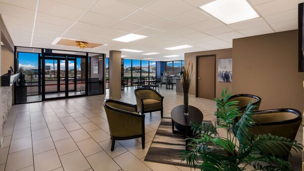 A spacious lobby with a view of the city, modern furniture, and a reception desk. - Quality Inn & Suites Round Rock - Austin North (Round Rock)