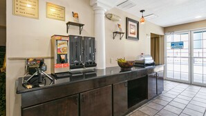 A hotel reception area with a counter, self-service coffee machines, a bowl of fruit, and a sign indicating the swimming pool is closed. - Best Western San Marcos (San Marcos)